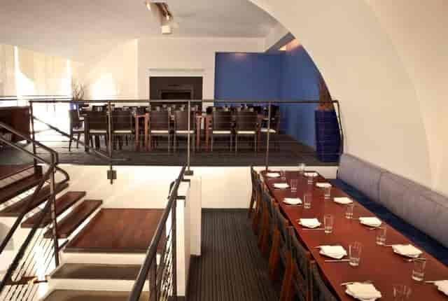 Stylish Mezzanine event space at Zaytinya with communal table for gatherings.