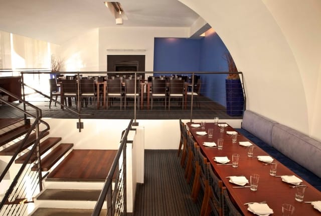 Stylish Mezzanine event space at Zaytinya with communal table for gatherings.