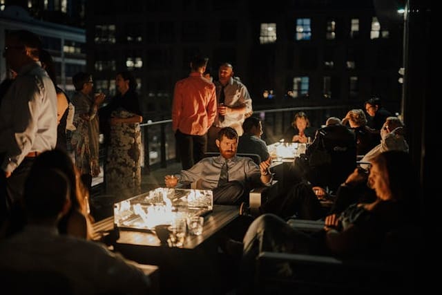 Rooftop event at District Winery with soft lighting and city skyline views.
