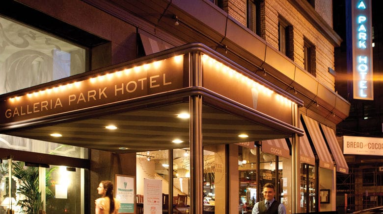 MacArthur Hotel entrance with awning, ideal for events and meetings.