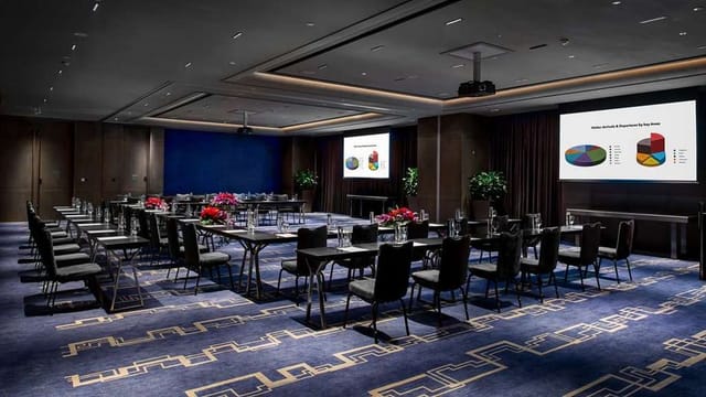 Modern conference room in Conrad Guangzhou with presentation screens for business meetings.