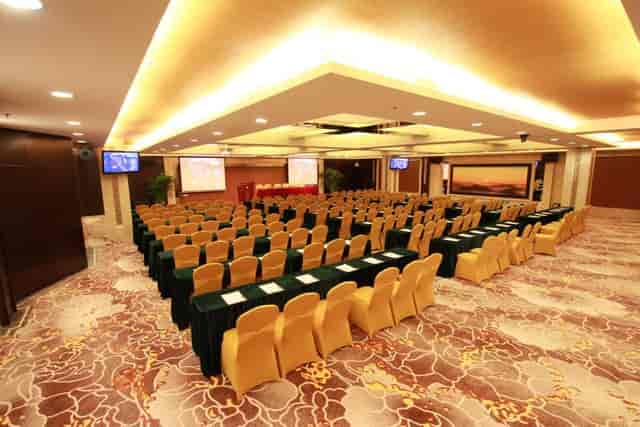Elegant conference room at Panyu Hotel for seminars, featuring gold seating and presentation screens.