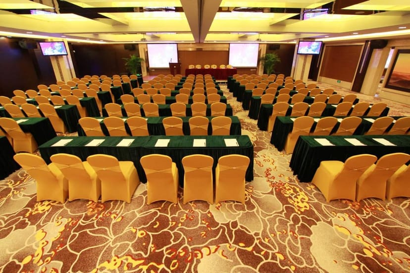 Multi-functional conference room at Panyu Hotel with gold chairs, ideal for corporate meetings.