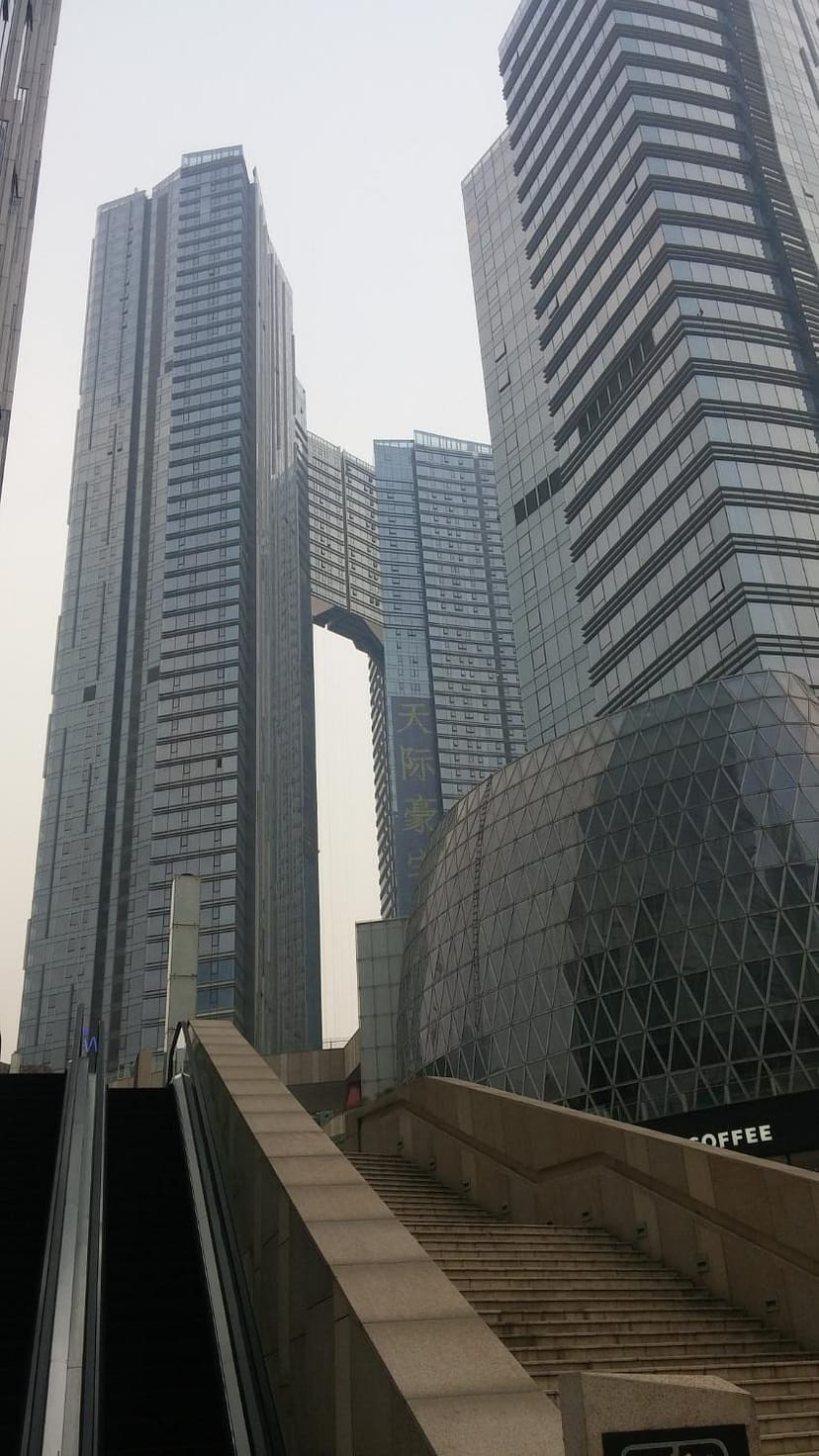 Modern conference hall at Xin Hua International Hotel with sleek glass buildings, ideal for events.