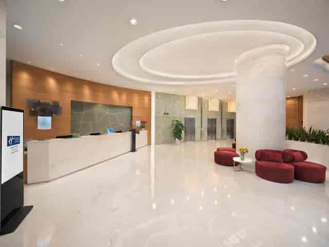 Modern hotel lobby with soft lighting, ideal for conferences and events.