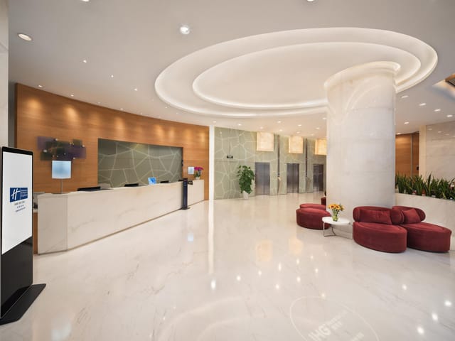 Modern hotel lobby with soft lighting, ideal for conferences and events.