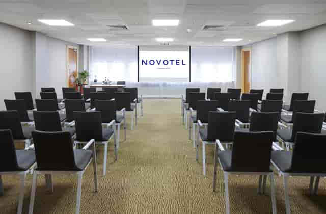 Meeting room at Novotel London West with black chairs, ideal for corporate events.
