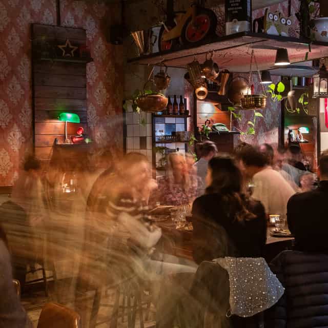 Lively restaurant interior ideal for networking events with warm lighting and vibrant decor.