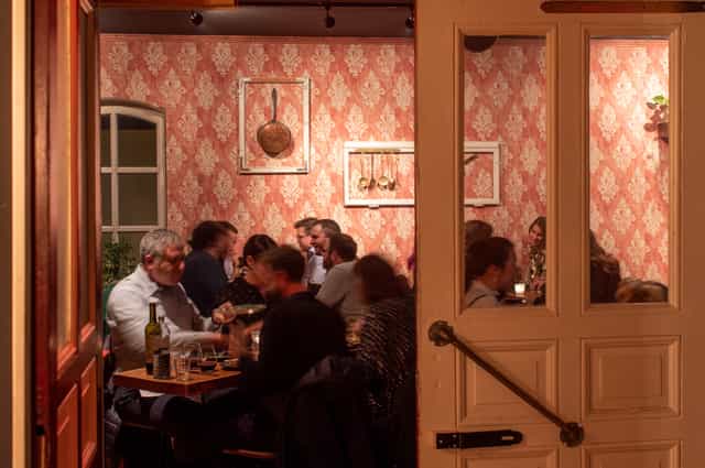 Cozy dining setting in Night Kitchen for intimate gatherings and corporate events.