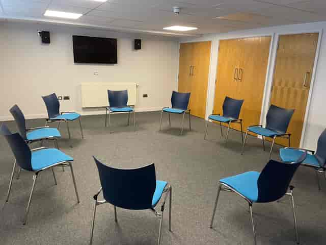 Versatile conference room with circular seating for interactive workshops and training events.