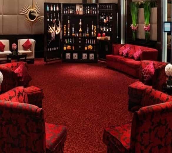 Elegant lounge with plush red seating for networking events at Sofitel Mumbai BKC.