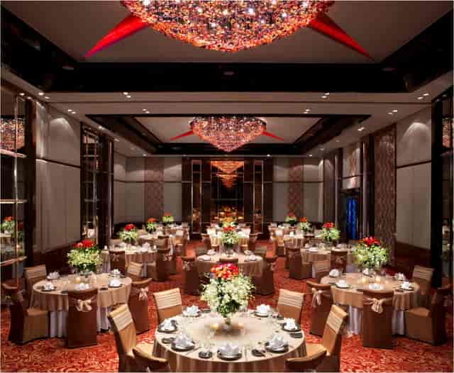 Elegant ballroom in Sofitel Mumbai BKC, featuring floral centerpieces for upscale events.