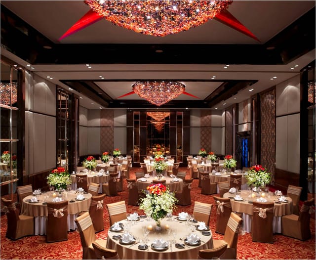 Elegant ballroom in Sofitel Mumbai BKC, featuring floral centerpieces for upscale events.
