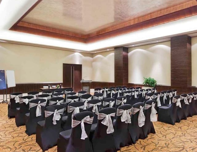 Champagne Ballroom in Novotel Mumbai, elegant black chairs for formal events and gatherings.