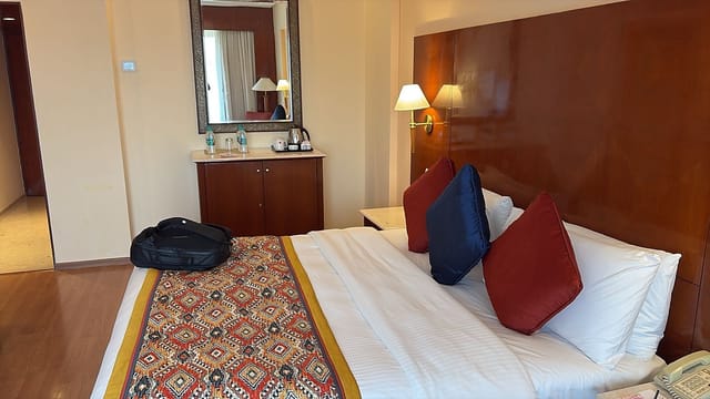Royal Room at The LaLiT Mumbai, cozy bed ideal for events and conferences.