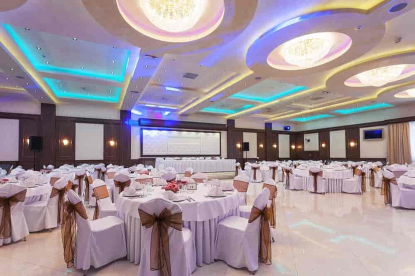 Elegant event space at Quorum, The LaLiT Mumbai with round tables and ambient lighting.