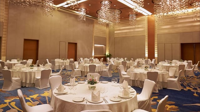 Elegant banquet hall set for corporate event at Courtyard Mumbai Airport.