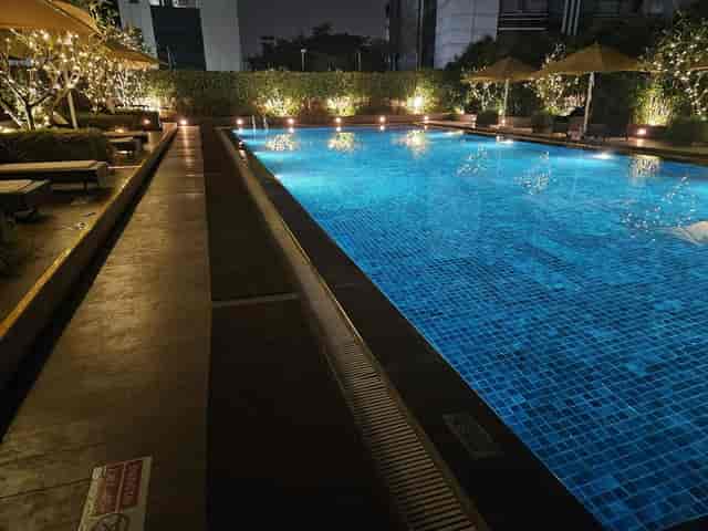 Illuminated pool area at Courtyard Mumbai Airport, ideal for evening events and networking.