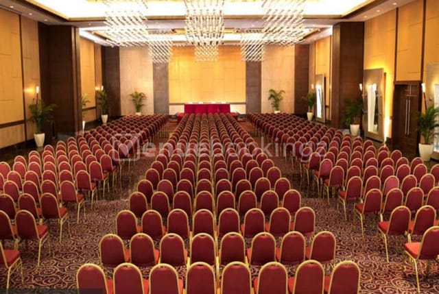 Spacious Banquet Hall with red chairs, ideal for conferences and seminars.