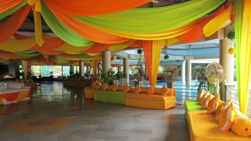 Conference Hall at The Retreat Hotel with vibrant orange decor, ideal for events and networking.
