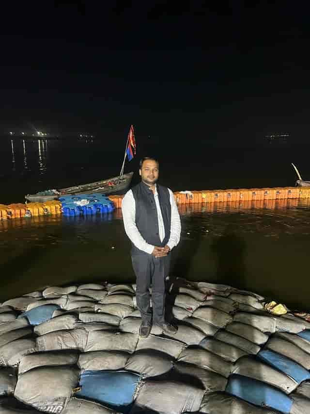Professional at night event in Mumbai Exhibition Center's Hall 4, waterfront venue ambiance.
