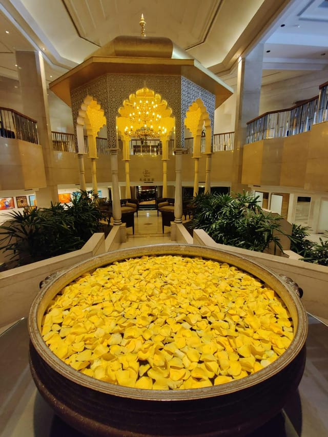 Grand Ballroom at The Leela Mumbai: elegant decor, yellow flower display, upscale events.