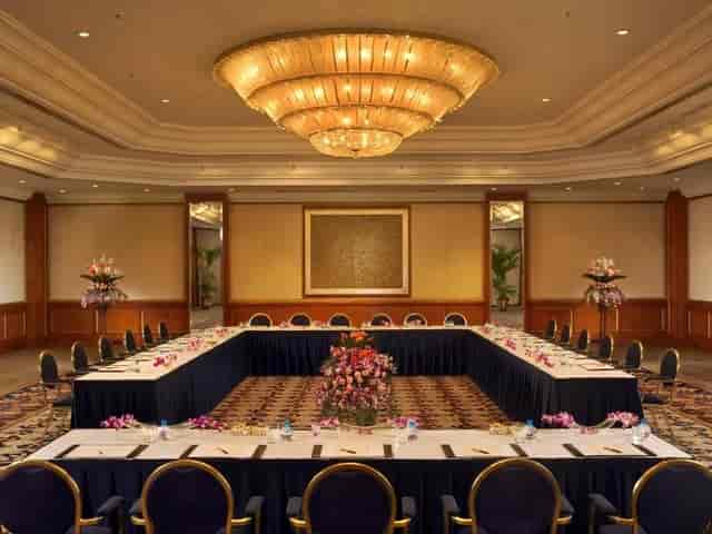 Grand Ballroom at The Leela Mumbai with U-shape tables for corporate events and conferences.