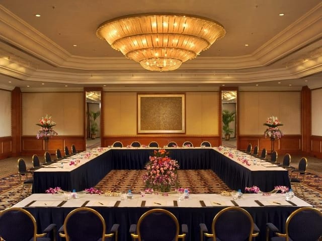 Grand Ballroom at The Leela Mumbai with U-shape tables for corporate events and conferences.