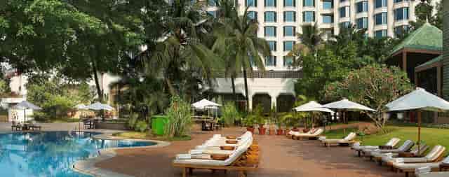 Business center at The Leela Mumbai with poolside lounge, ideal for serene corporate events.