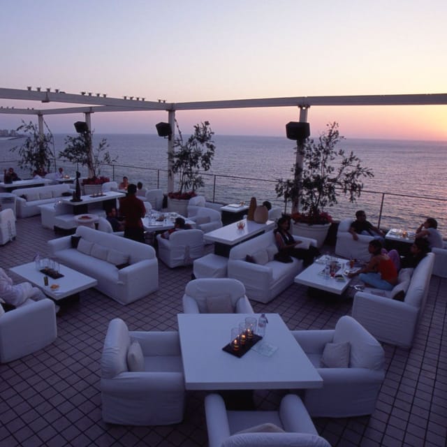 Chic outdoor restaurant with ocean view at sunset, perfect for upscale events and receptions.