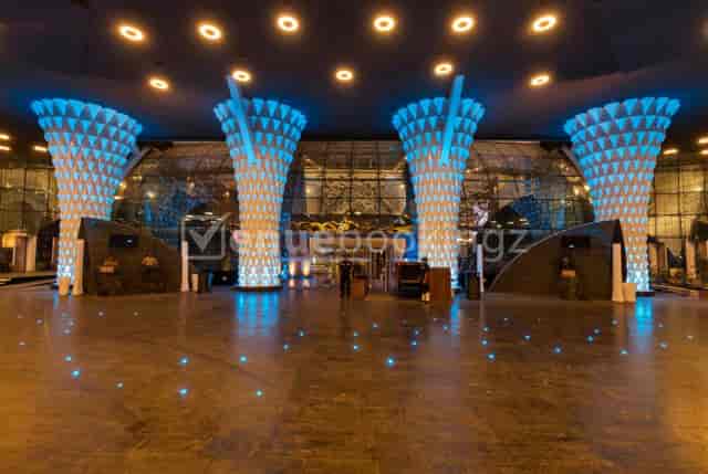 Ruby Ballroom at Hotel Sahara Star with blue-lit pillars, perfect for corporate events and gatherings.