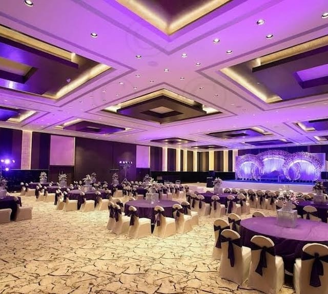 Elegant banquet facilities with purple accents for gala events at Hotel Sahara Star.