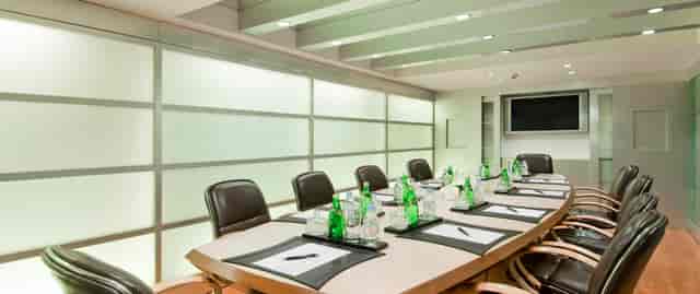 Modern Hilton Mumbai airport boardroom with sleek table, ideal for meetings and presentations.