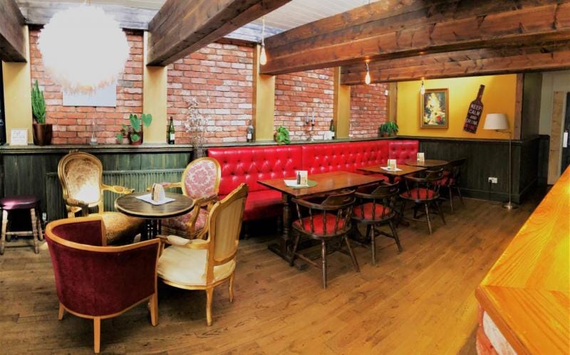 Cozy lounge bar with rustic charm, perfect for networking events and casual meetings.