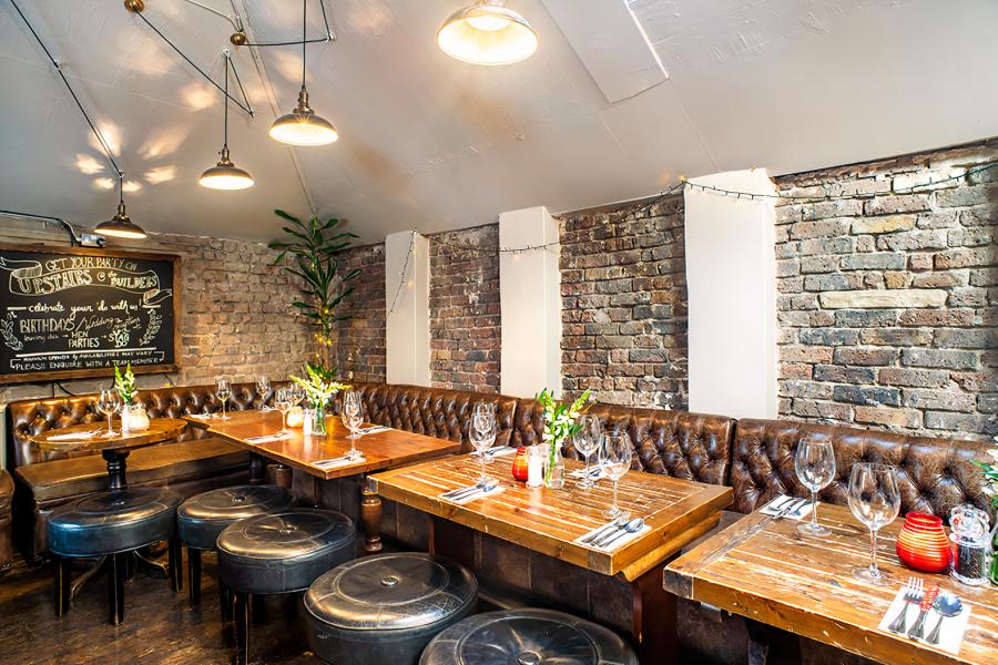 Lounge bar at Builders Arms: rustic charm, warm lighting; perfect for corporate events. - Banner