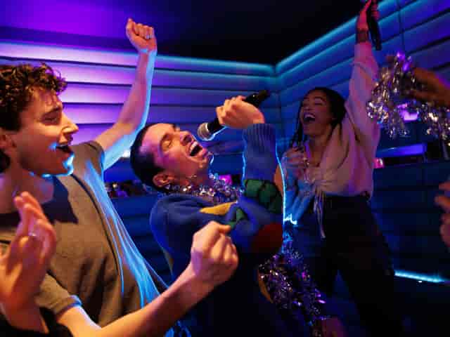 Christmas party karaoke at Lucky Voice Holborn, vibrant atmosphere for team-building fun.