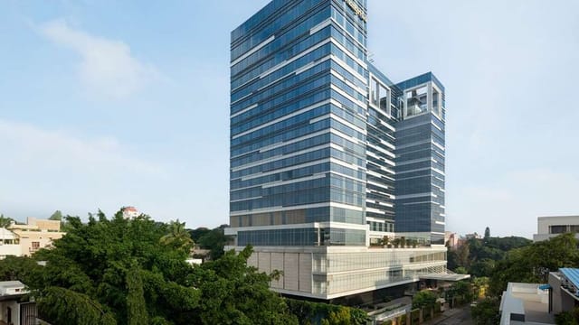 Krishna in Shangri-La Hotel Bengaluru, a modern venue for corporate events with glass windows.