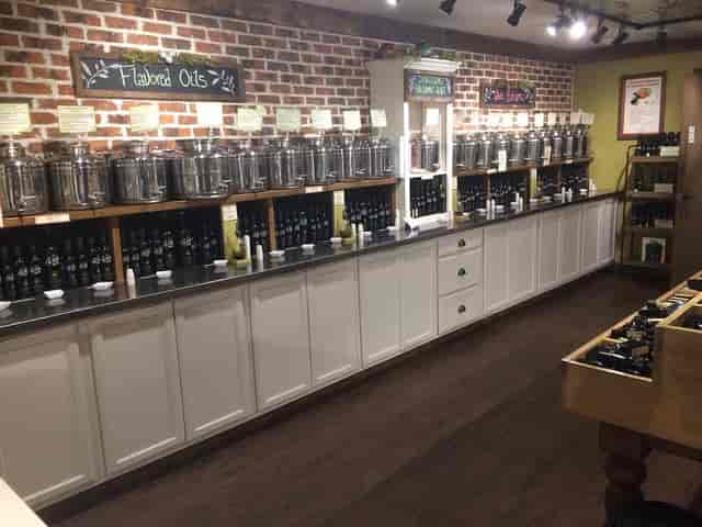 Welcoming Olive Bar tasting room with stainless steel dispensers for culinary workshops.