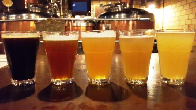 Craft beers in clear glasses at The Biere Club for tastings and networking events.