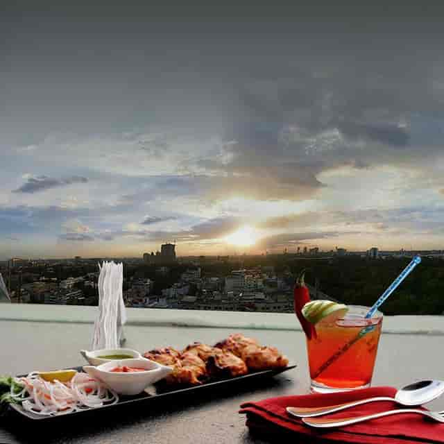 Rooftop bar with sunset view, elegant catering for events and social gatherings.