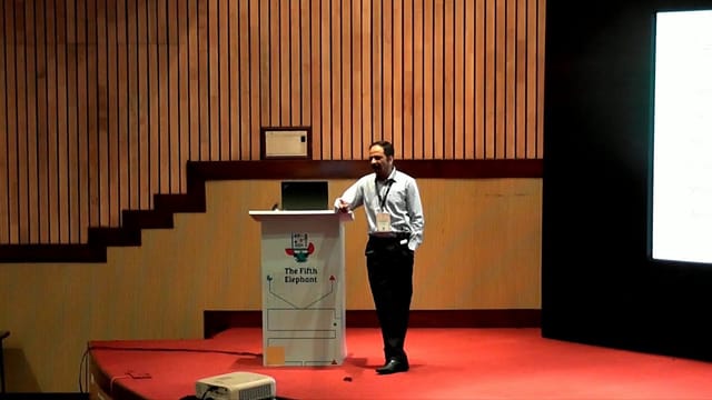 Speaker presenting in Auditorium 3, showcasing engaging visuals for event management.