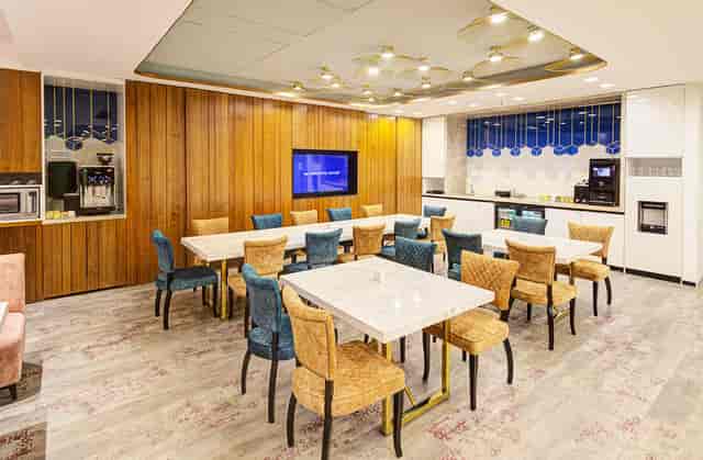 Modern Function Room with light wood paneling, perfect for networking and team meetings.