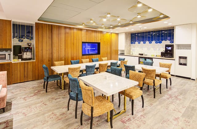 Modern Function Room with light wood paneling, perfect for networking and team meetings.