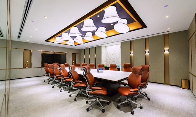 Modern conference room with spacious table, perfect for corporate meetings and presentations.