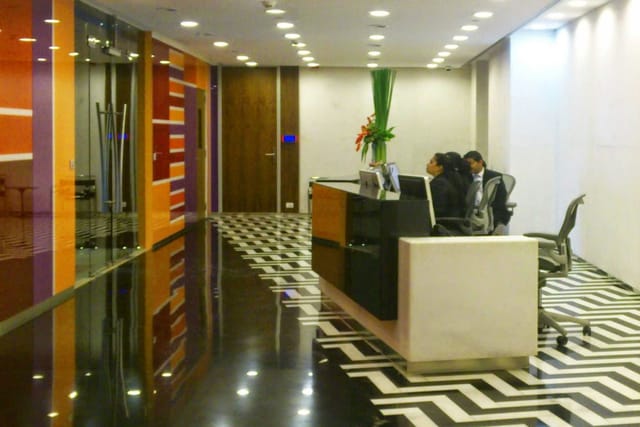 Sleek breakout area with geometric floors, ideal for meetings and networking events.