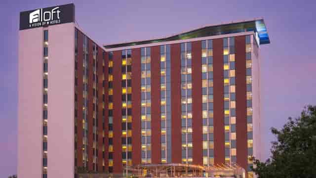 Modern Aloft hotel in Bengaluru with ample windows for business events and gatherings.