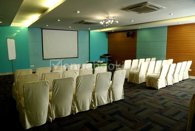 Banquet hall in The Verda Saffron, featuring a professional conference setup with turquoise accents.