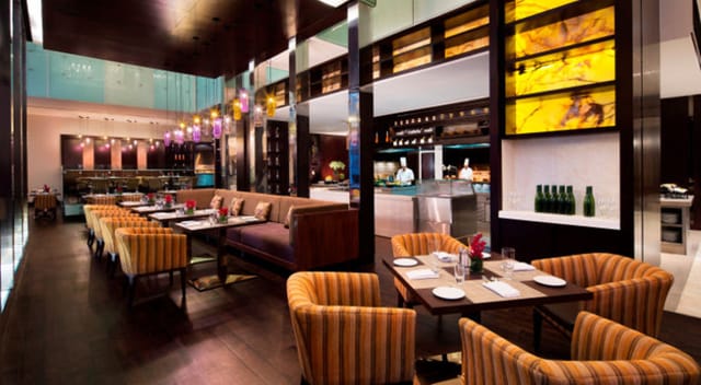 JW Kitchen at JW Marriott Bengaluru: upscale restaurant with modern decor, perfect for events.
