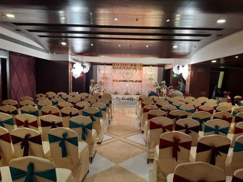 Elegant banquet hall with colorful sashes, perfect for weddings or corporate events.