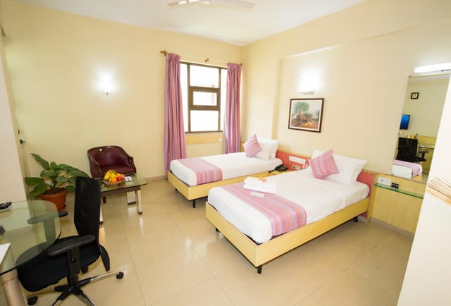 Conference center room with twin beds, ideal for business events and collaboration.